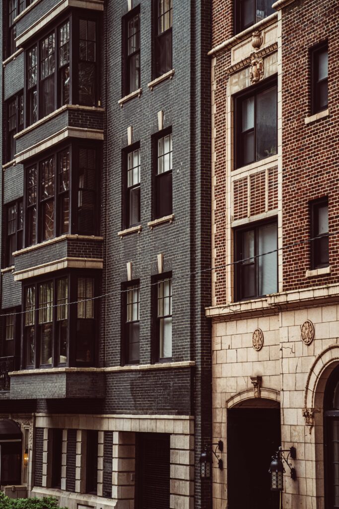 A modern facade blends with classic brick architecture in Chicago's urban landscape.