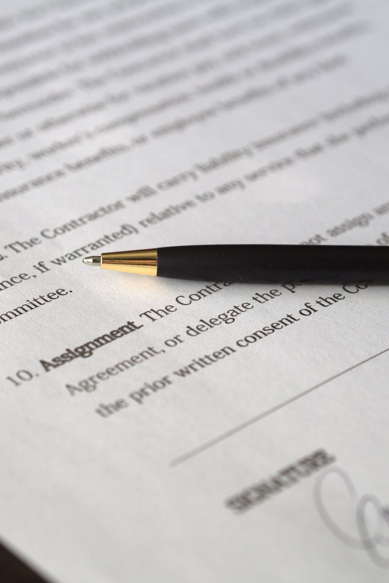 Close-up image of a business contract and pen, signed and ready for agreement.